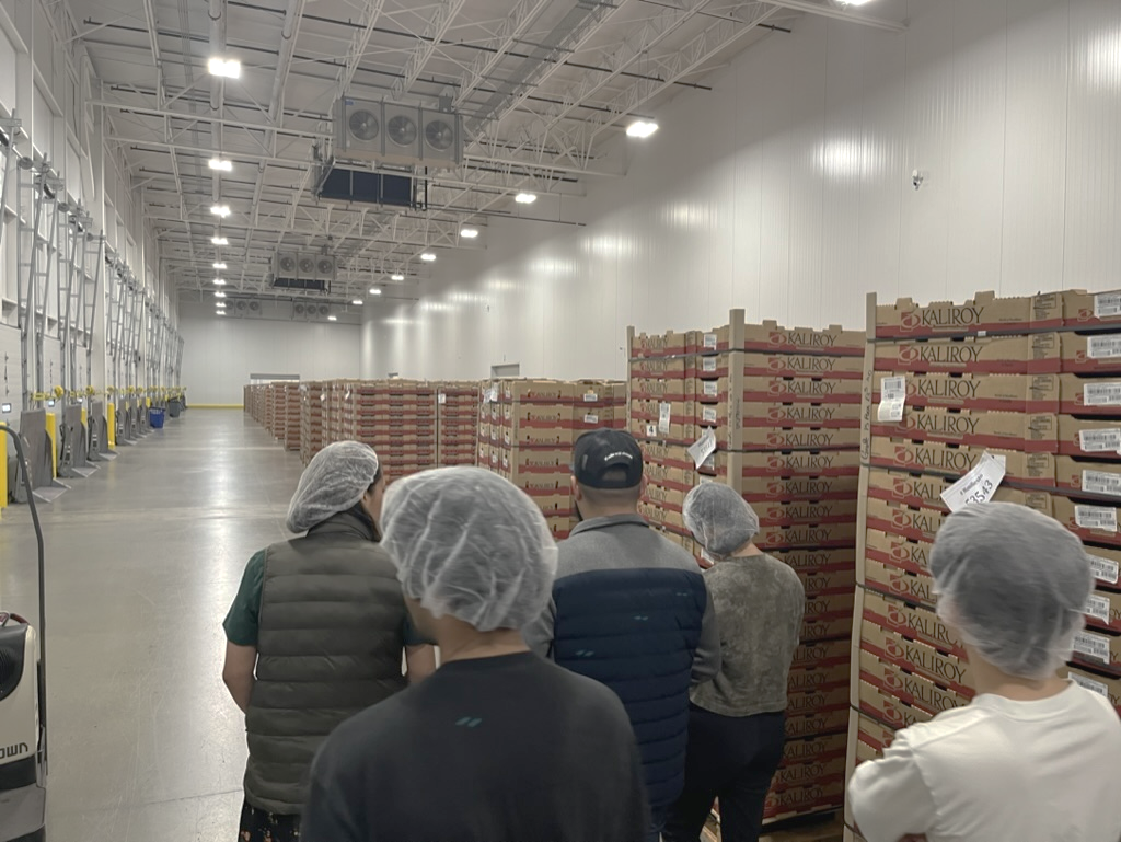 Produce distributors in a warehouse during field research